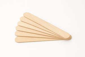 Fanned display of COZ Senior Tongue Depressors used for tattoo skin prep.