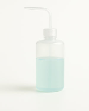 COZ Squeeze Bottle partially filled with blue liquid – ideal precision tool for tattoo professionals.