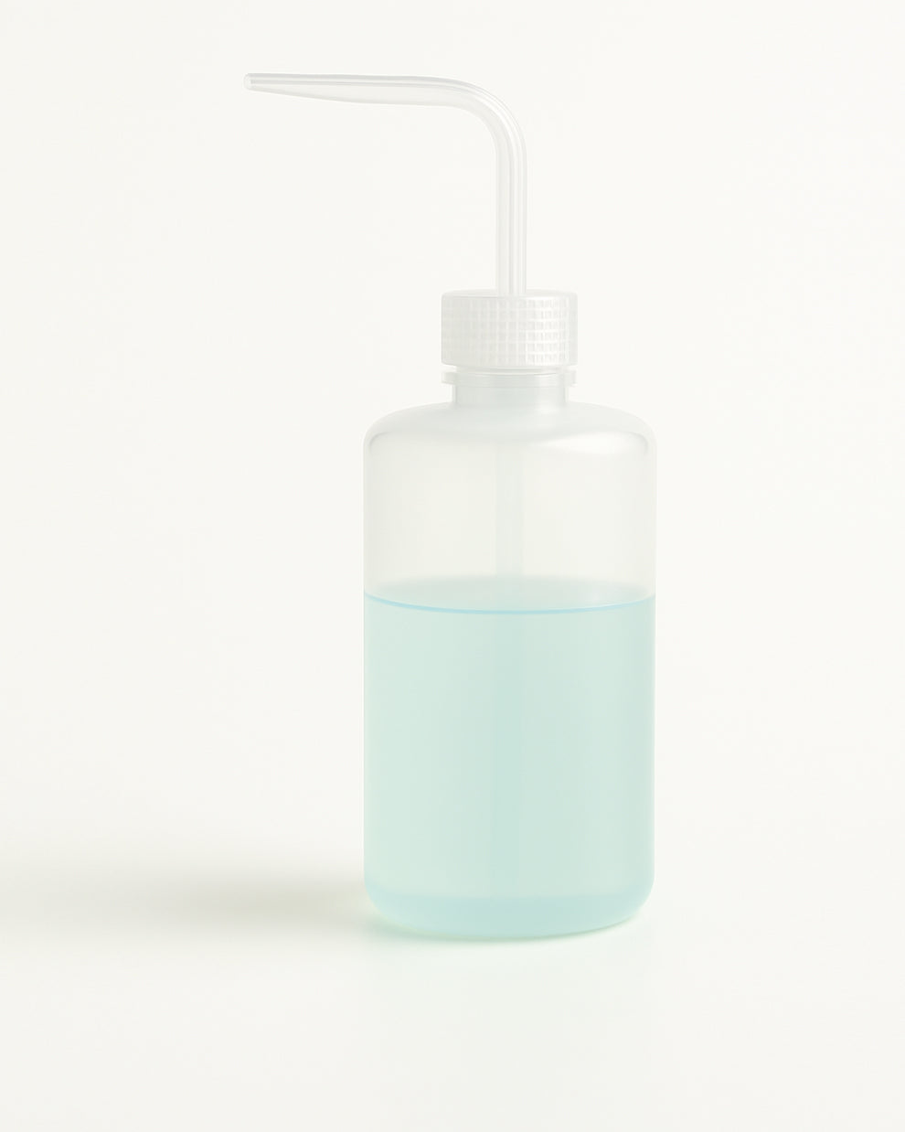 COZ Squeeze Bottle partially filled with blue liquid – ideal precision tool for tattoo professionals.