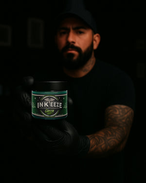 Tattoo artist holding INK-EEZE Green Tattoo Ointment 16oz Jar by COZ Tattoo Supplies Canada — professional vegan tattoo aftercare balm for healing fresh tattoos