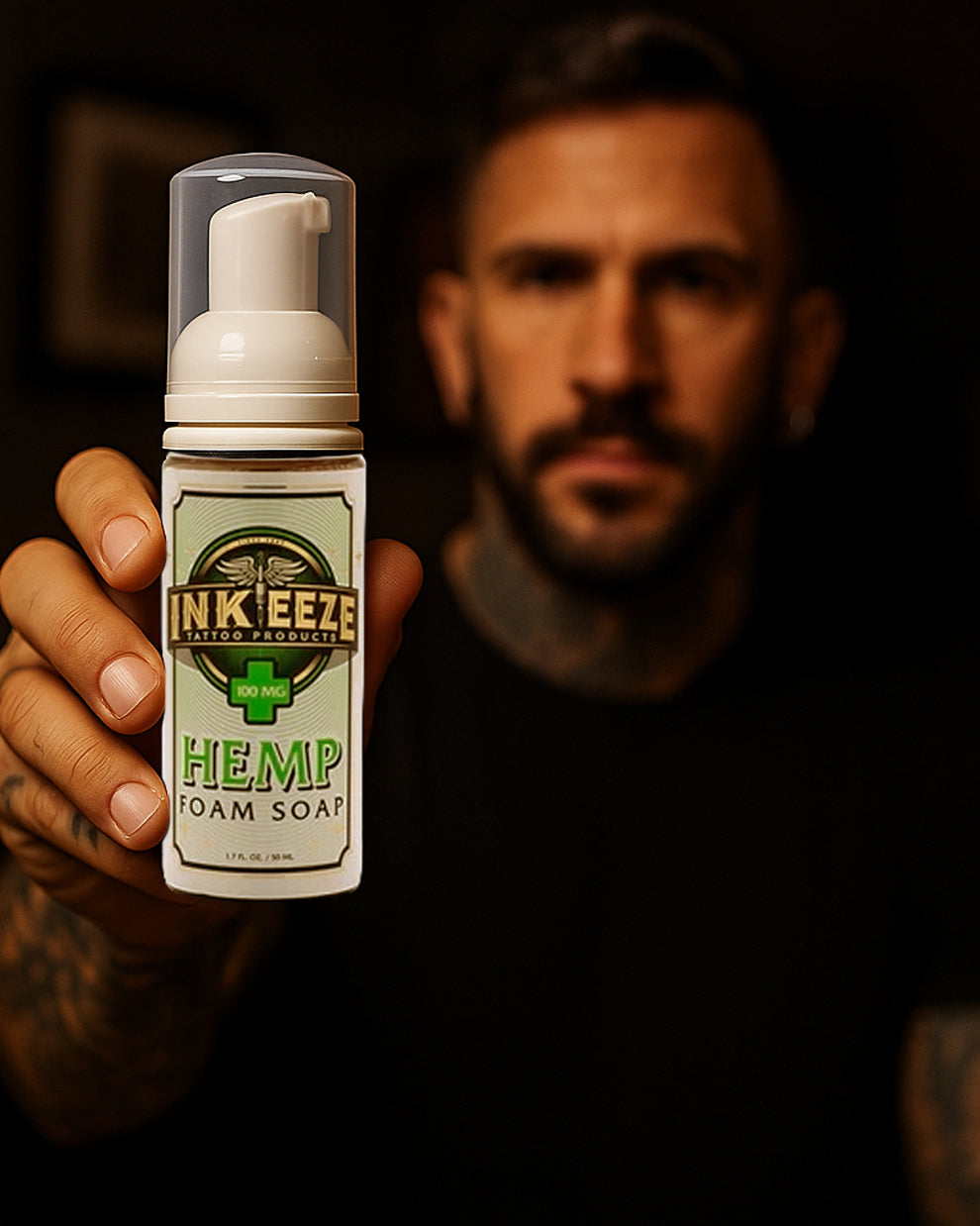 Tattoo artist holding INKEEZE Hemp Foam Soap 1.7oz by COZ Tattoo Supplies Canada, premium hemp based tattoo cleansing foam