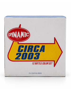 A white cardboard box for a Dynamic Vodka Co. 'Circa 2003' 12-bottle color set, featuring a large yellow arrow and red logo on a white background.