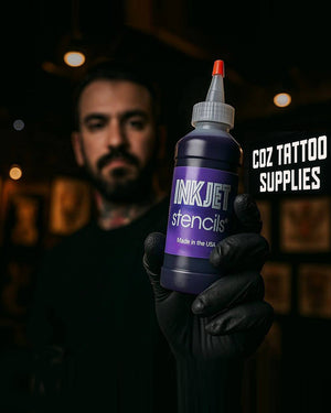 Tattoo artist holding InkJet Stencils solution bottle in studio – available at COZ Tattoo Supplies Canada.