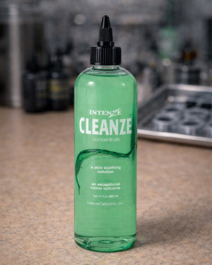 Intenze Cleanze Concentrate 12 oz bottle on professional tattoo artist workstation, skin soothing tattoo solution, Coz Tattoo Supplies