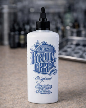 Intenze Formula 23 Original tattoo ink bottle placed on tattoo artist work table