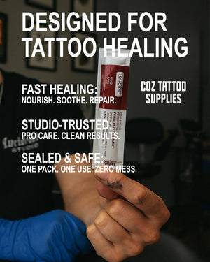 Tattoo aftercare ointment packet held by artist – fast healing and studio-trusted formula.