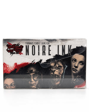 World Famous Noire Ink box featuring a black and white graphic design with red accents and character portraits of Thomas Carlyle Julliard.