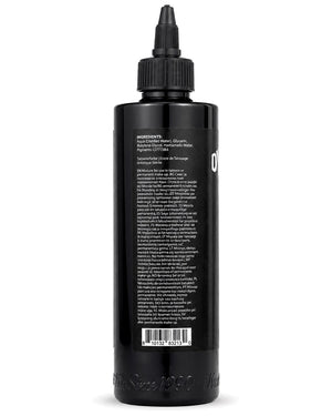 Black tattoo ink bottle with label on a white background