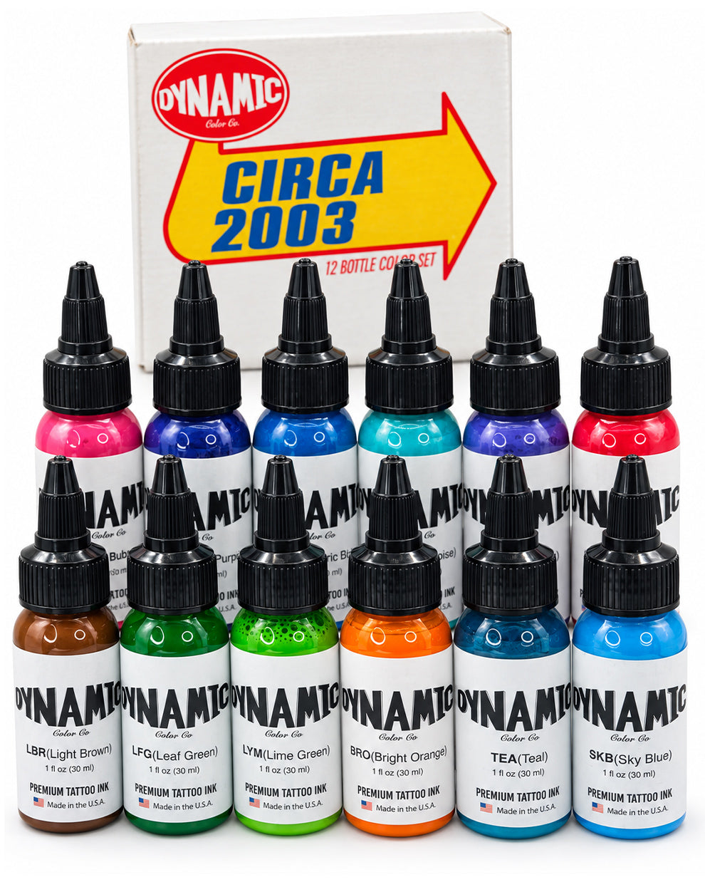 A set of 12 Dynamic Ink 'Circa 2003' premium tattoo inks arranged in two rows in front of their original white and yellow box. The inks are shown in a variety of vibrant colors including pink, blue, teal, red, brown, green, orange, and sky blue.