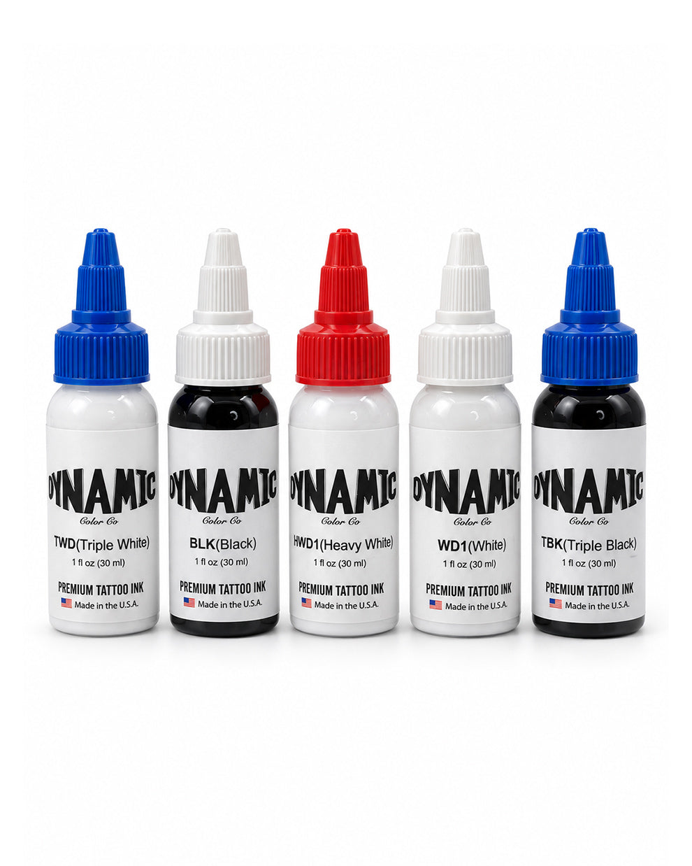 Five bottles of Dynamic brand premium tattoo ink arranged in a row on a white background. The bottles are labeled TWD (Triple White) with a blue cap, BLK (Black) with a white cap, HWD1 (Heavy White) with a red cap, WDI (White) with a white cap, and TBK (Triple Black) with a blue cap.
