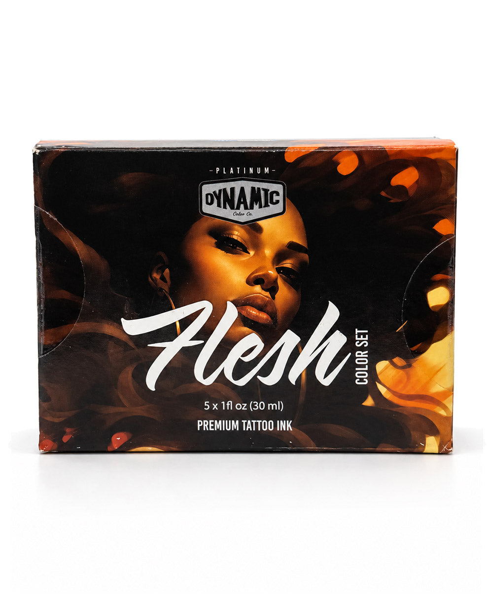 A box of Dynamic Platinum Flesh Color Set premium tattoo ink, featuring a dark design with a woman's face and orange flame-like accents, on a white background.