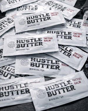 Multiple Hustle Butter Tattoo Balm Deluxe aftercare sachets arranged together, professional tattoo balm sold by COZ Tattoo Supplies