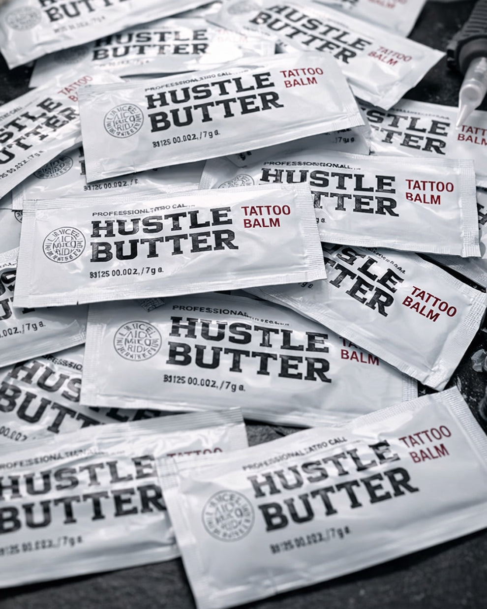Multiple Hustle Butter Tattoo Balm Deluxe aftercare sachets arranged together, professional tattoo balm sold by COZ Tattoo Supplies