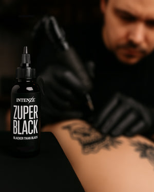 Tattoo artist using Intenze Zuper Black Tattoo Ink during session – deep black ink for bold lines and solid fills, trusted by Canadian professionals.