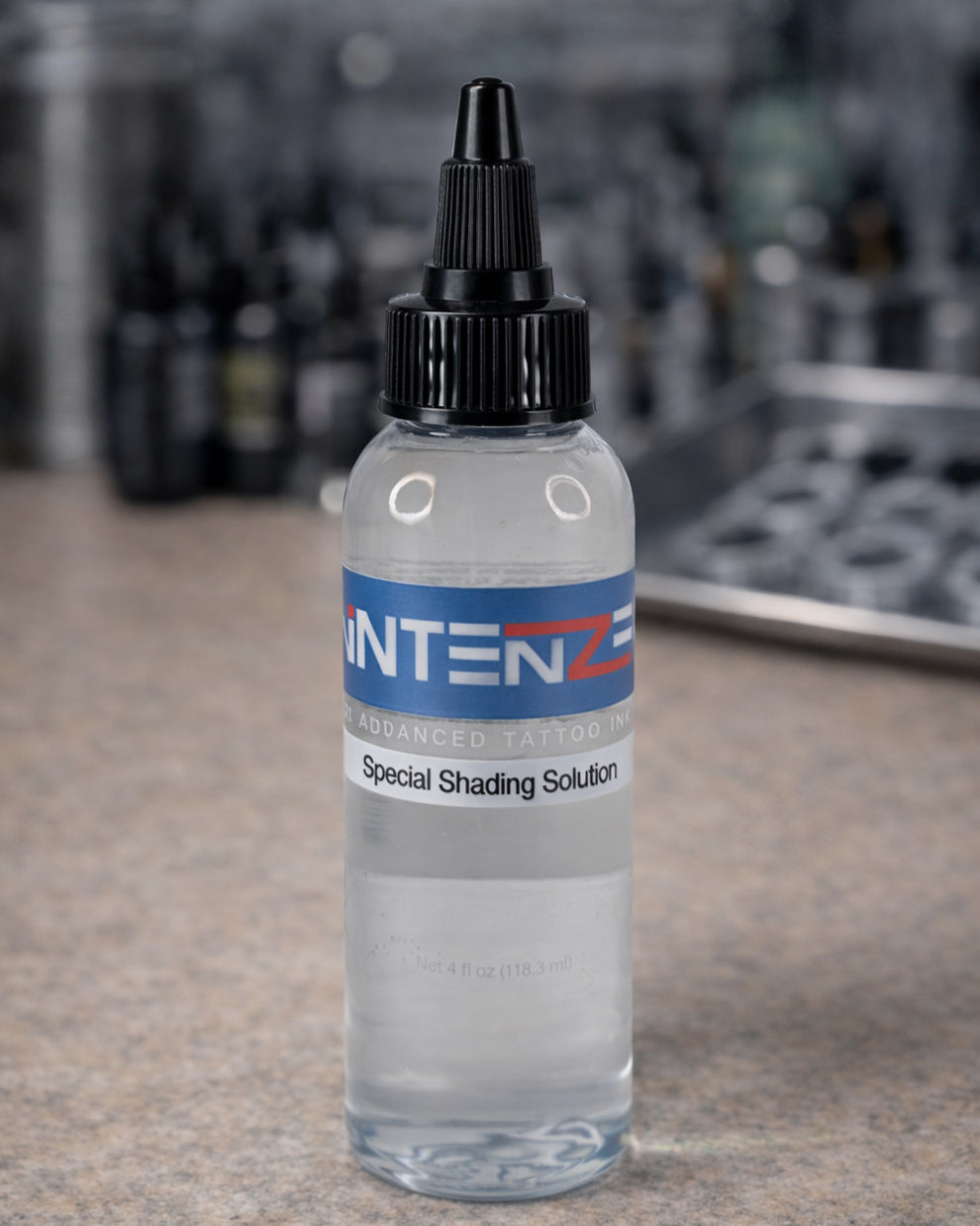 Intenze Special Shading Solution 4 oz bottle on tattoo artist workstation by Coz Tattoo Supplies