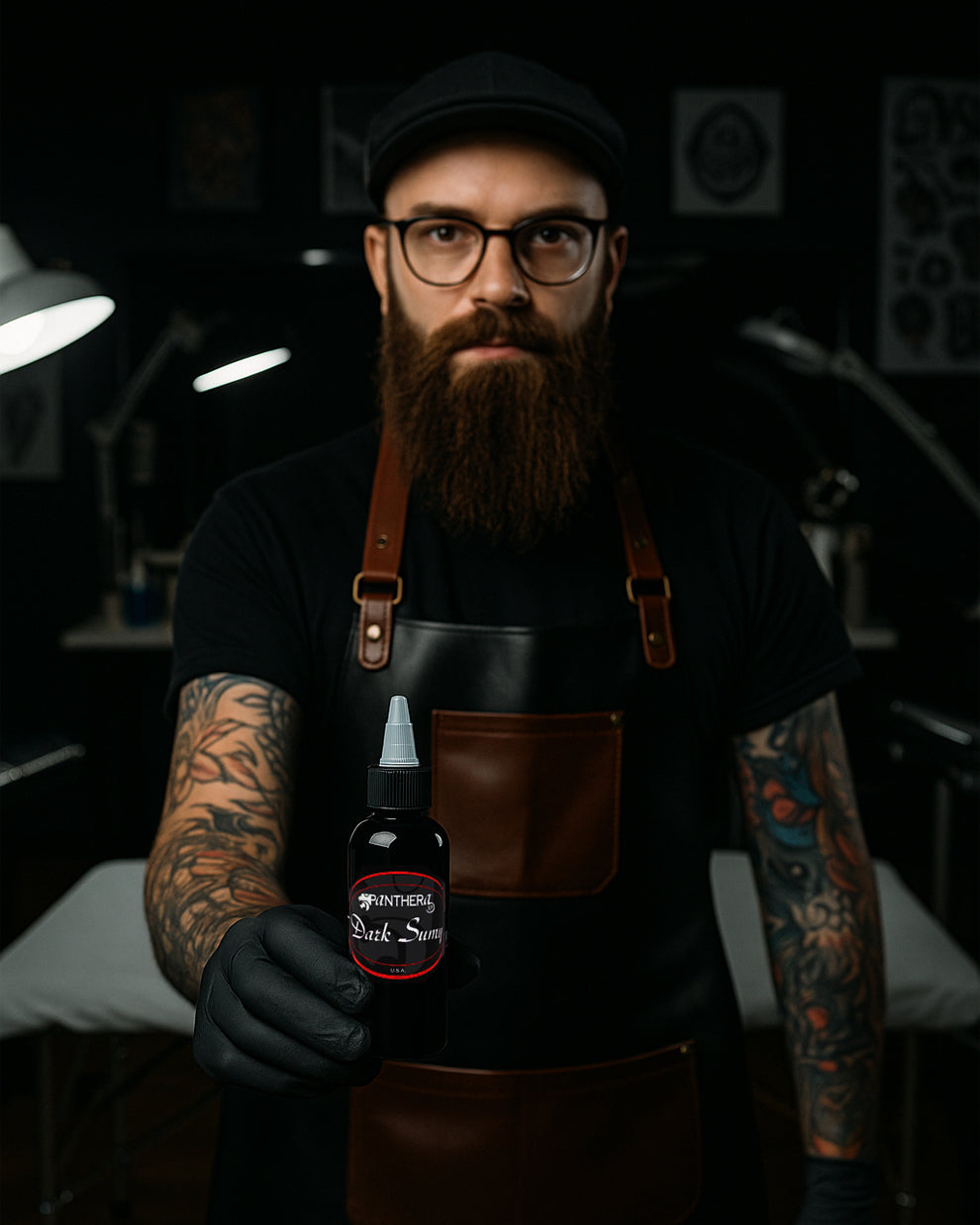 Tattoo artist holding a bottle of Panthera Dark Sumy Tattoo Ink in a studio setting, showcasing its bold black pigment and premium packaging.